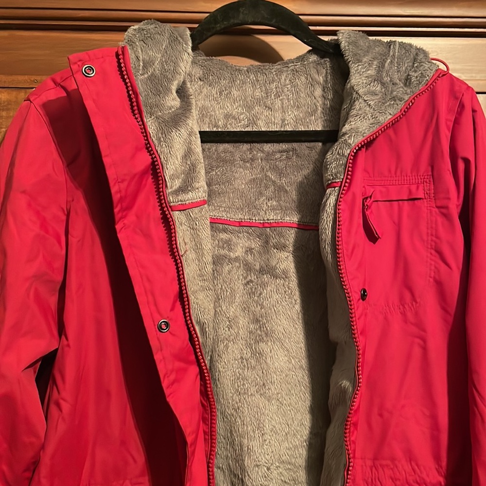 Red rain jacket. super soft in the inside. Not sure of size I’d say it’s a M
